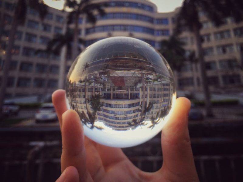 hand holding up a crystal ball